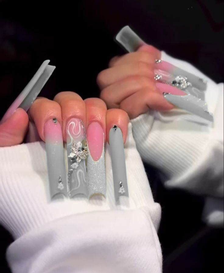 Trendy Gray and Pastel Pink Nail Design with Glitter, Swirls, and Rhinestone Accents.