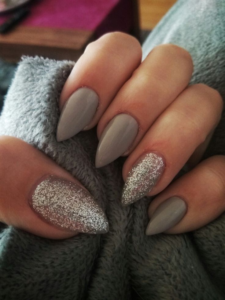 Sophisticated Almond-Shaped Nail Design with Muted Gray and Sparkling Silver Accents.