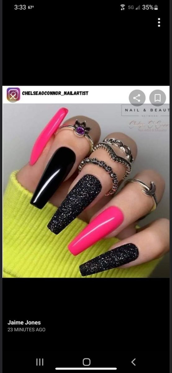 Chic Bold Nail Design with Glossy Black, Vibrant Pink, and Glittery Accents.