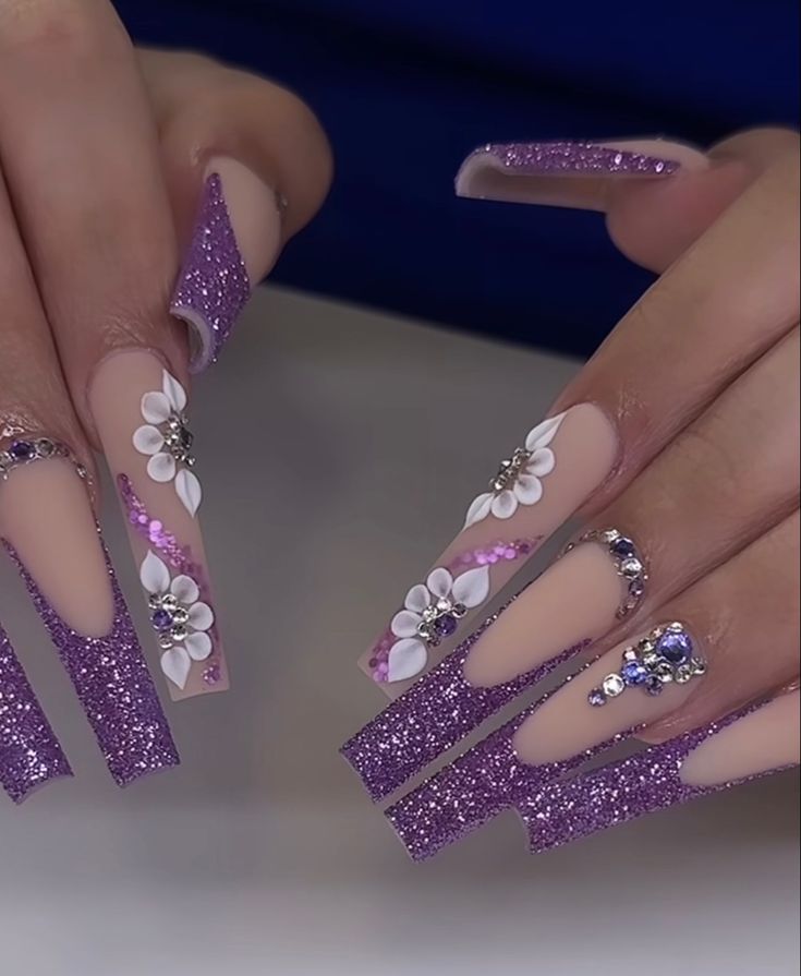 Elegant Sparkly Purple Nail Design with Matte and Glossy Finishes, Floral Accents, and Rhinestones.