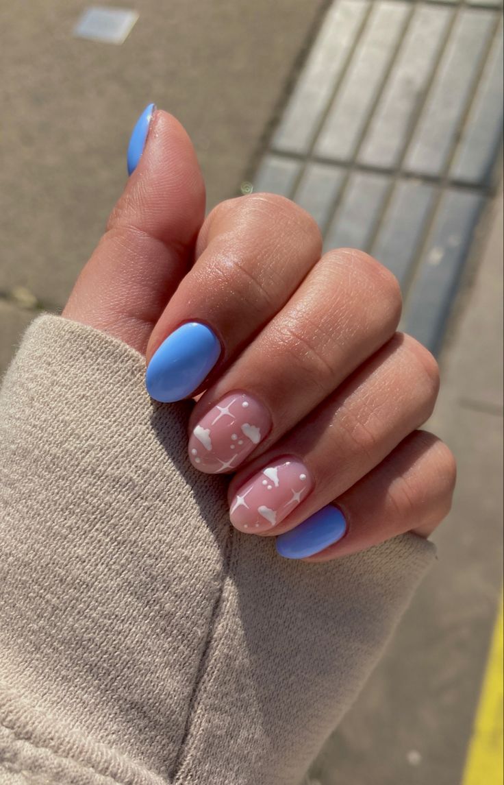 Chic Pastel Blue and Pink Nail Design with Delicate White Patterns.