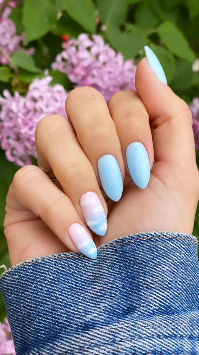 Chic Pastel Blue Nail Design with Elegant Shape and Whimsical Patterns for a Fresh Spring/Summer Vibe.