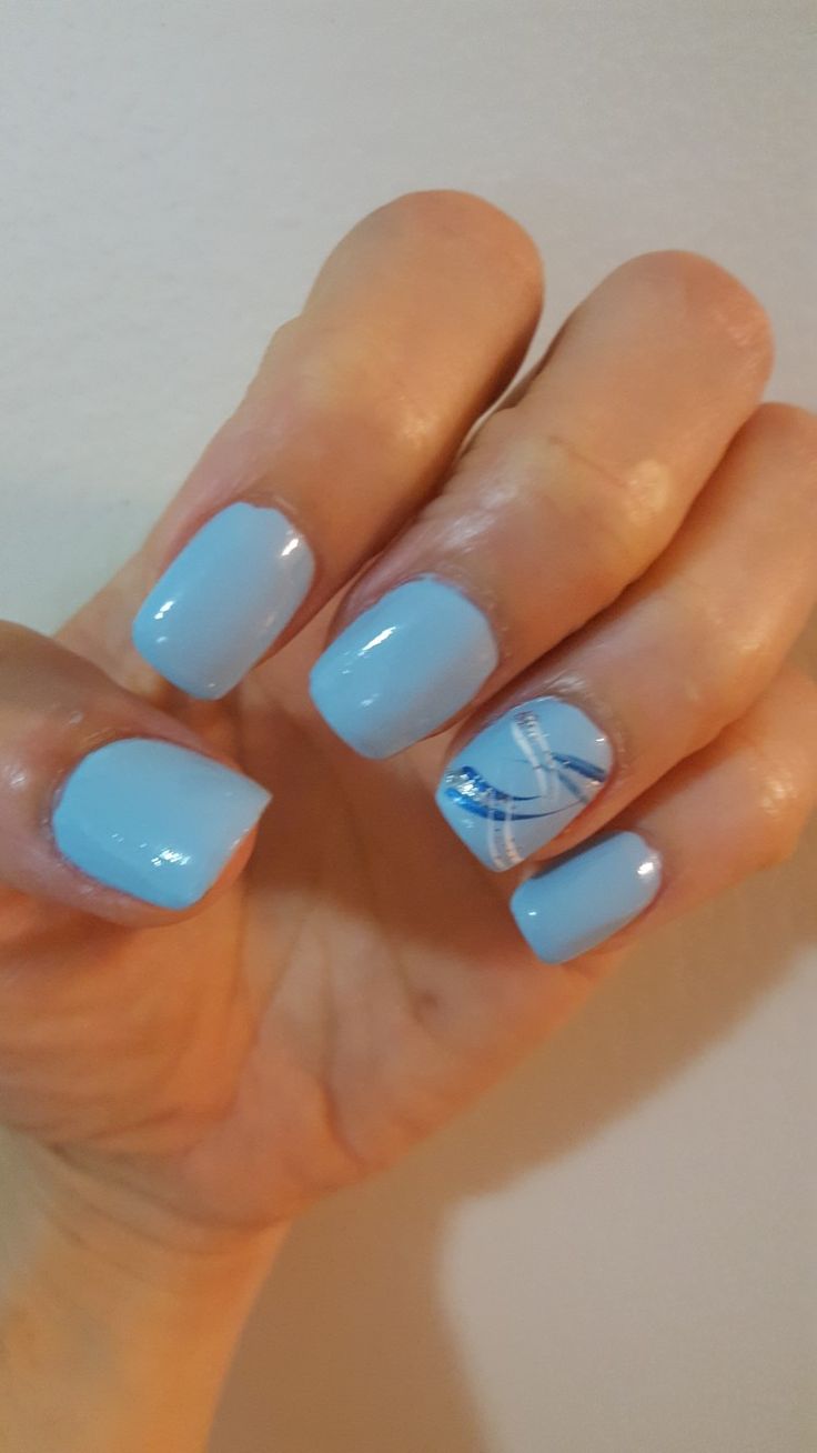 Elegant Soft Blue Nail Design with Glossy Finish and Artistic Swirls.