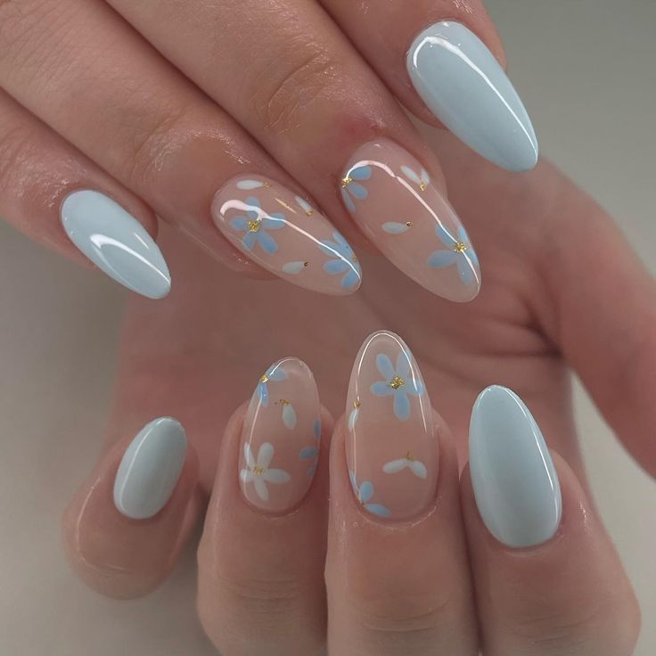 Elegant Floral Nail Design with Pastel Blue, Nude Accents, and Golden Highlights.