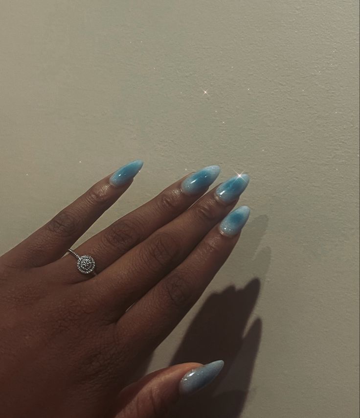 Elegant Ombre Blue Nail Design: A Soft Gradient from Deep to Light Shade.