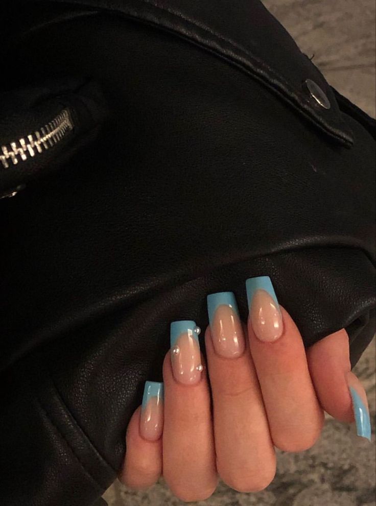 Chic Nail Design: Elegant Soft Blue Tips on Translucent Base with Subtle Embellishments.