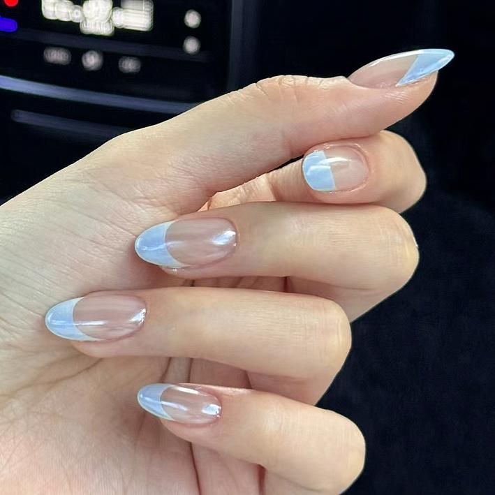 Chic French-Inspired Nail Design in Clear and Soft Blue Tones.