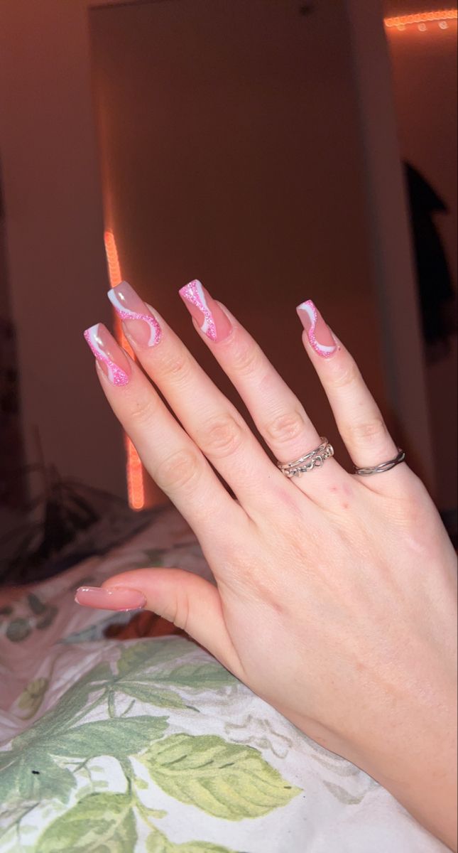 Playful Soft Pink and White Nail Design with Intricate Detailing and Elegant Ring Accents.