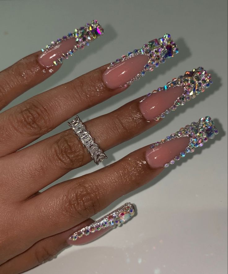 Glamorous Long Nails with Shimmering Rhinestones and Stylish Statement Ring.