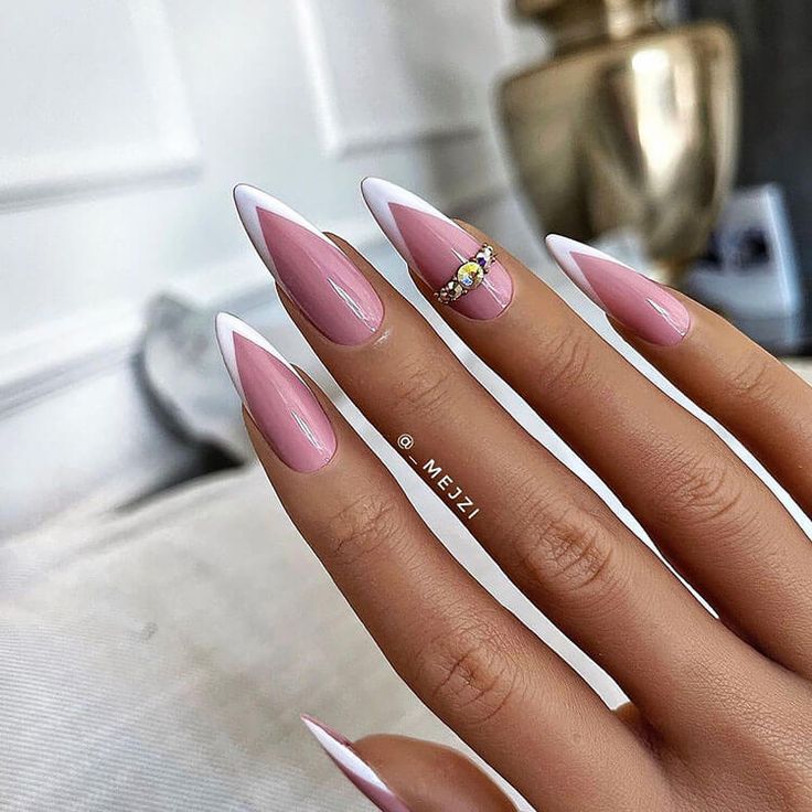 Chic Almond-Shaped Nails: Classic French Manicure with Glamorous Jewel Accent.