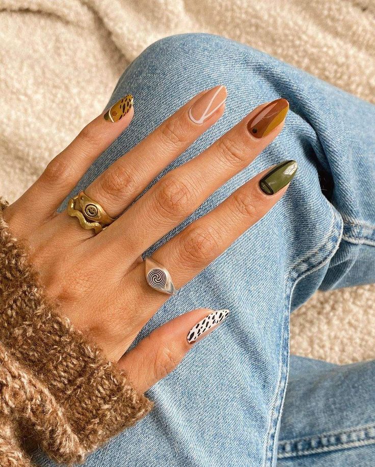 Elegant Earthy Nail Design with Intricate Patterns and Chic Accessories.