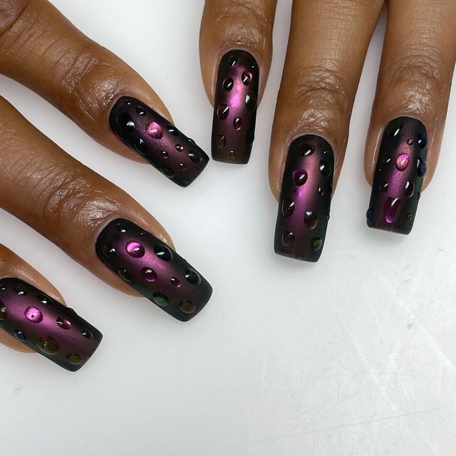 Elegant Black Base Nail Design with Gradient Purple and Pink Raindrop Accents.