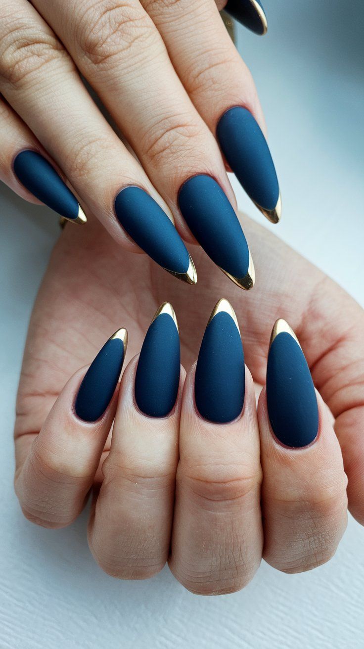 Chic Matte Blue Nails with Glossy Gold Tips: A Sophisticated Statement Design.