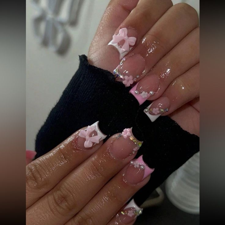 Elegant Floral Nail Design with Soft Pink and White Accents for Special Occasions.