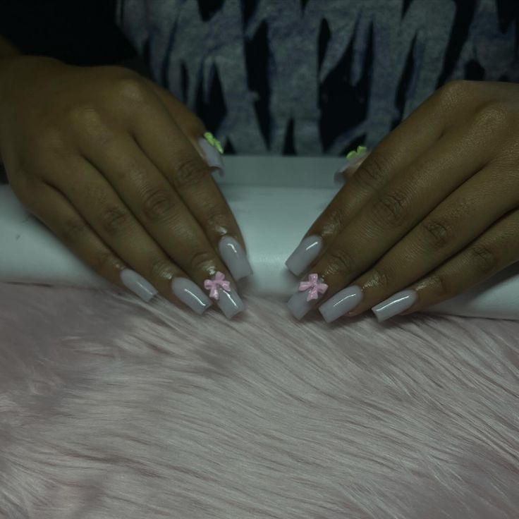 Sophisticated Chic: Elegant Pale Pink Nail Design with Pastel Bows.