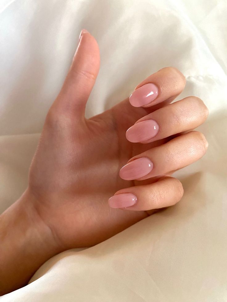 Elegant Soft Pink Manicure: A Versatile Choice with Glossy Finish for Every Occasion.