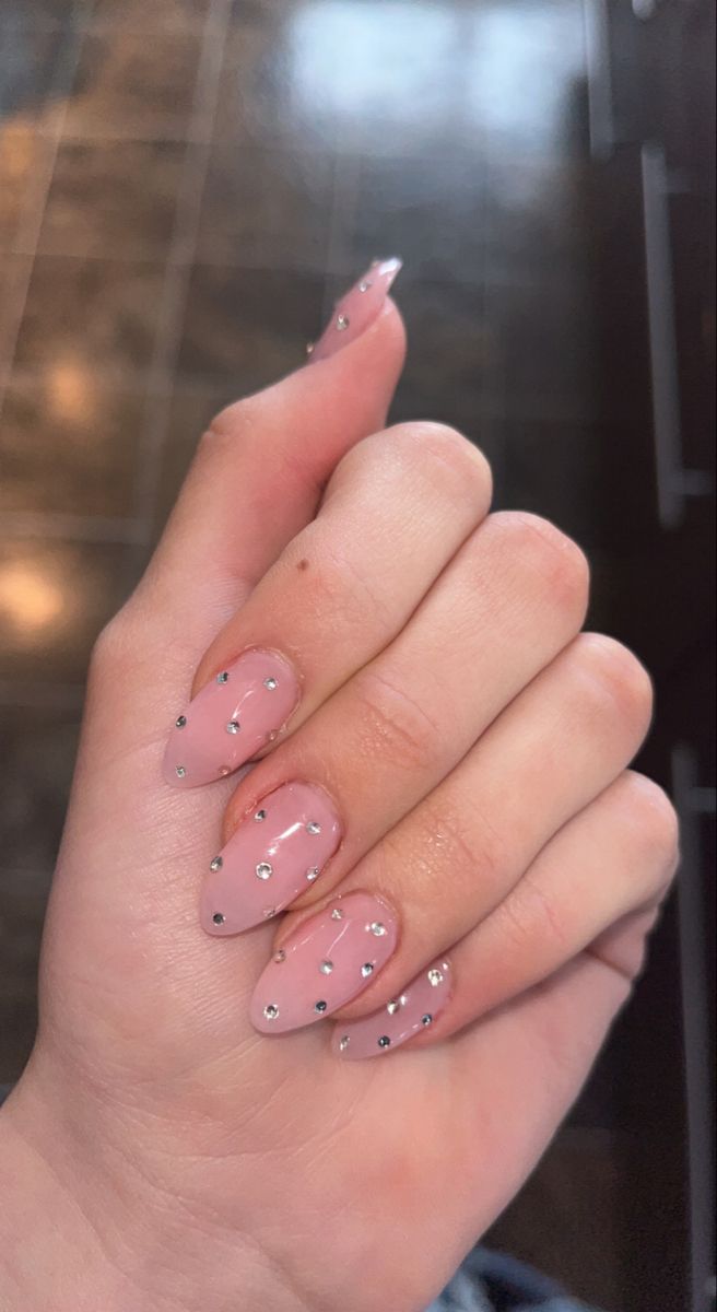 Sophisticated Soft Pink Ombre Nail Design with Glamorous Rhinestone Accents.