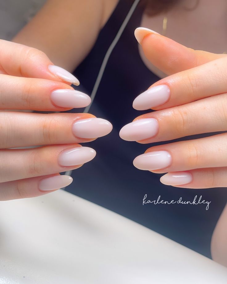 Sophisticated Almond-Shaped Nails with Translucent Pink Polish for Modern Elegance