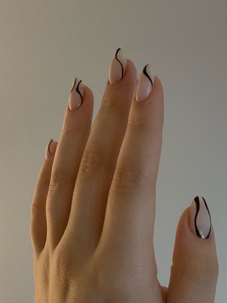 Chic Nude and Black Nail Design: Sophisticated, Playful, and Trendy Artistry.