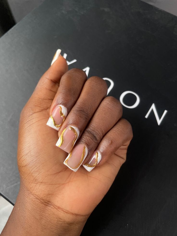 Chic Nude French Tip Nails with Elegant Gold Swirls for Any Occasion.