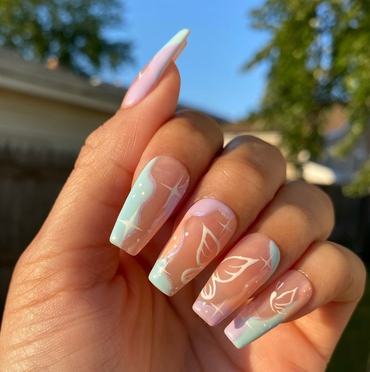 Elegant Pastel Ombre Nails with Intricate White Designs for Any Occasion