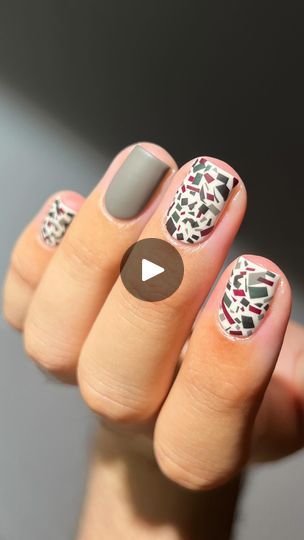 Modern Artistic Nail Design: Muted Gray with Vibrant Abstract Geometric Patterns.