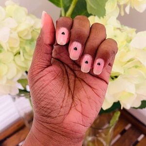 Elegant Minimalist Nail Design: Soft Nude Base with Strategic Black Dots