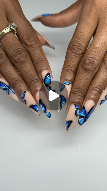 Elegant Almond-Shaped Nails Adorned with Striking Blue Butterfly Art on a Nude Background