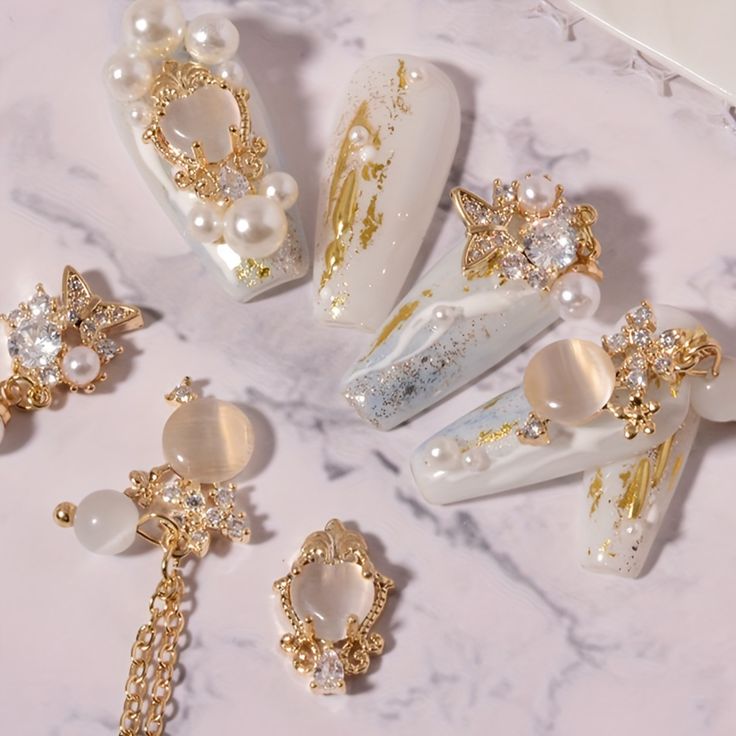 Sophisticated Nail Design: Soft Whites with Shimmering Gold and Luxurious Accents.