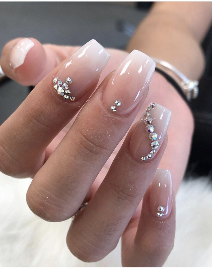 Chic Ombre Nails: Gradient Nude to Soft Pink with Sparkling Rhinestones.