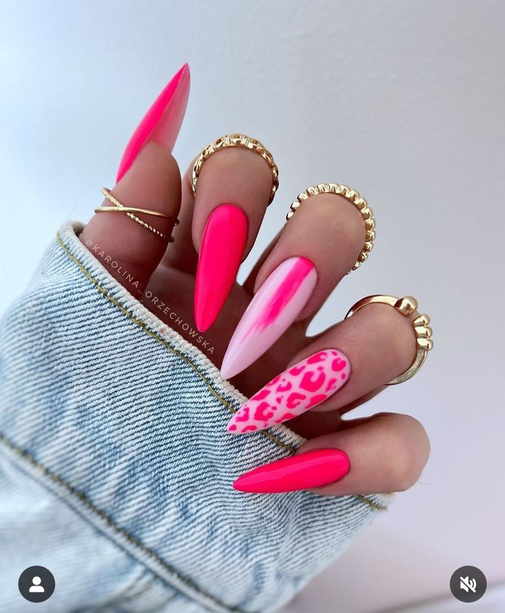 Bold Vibrant Pink Nail Design with Playful Accents and Chic Gold Rings.