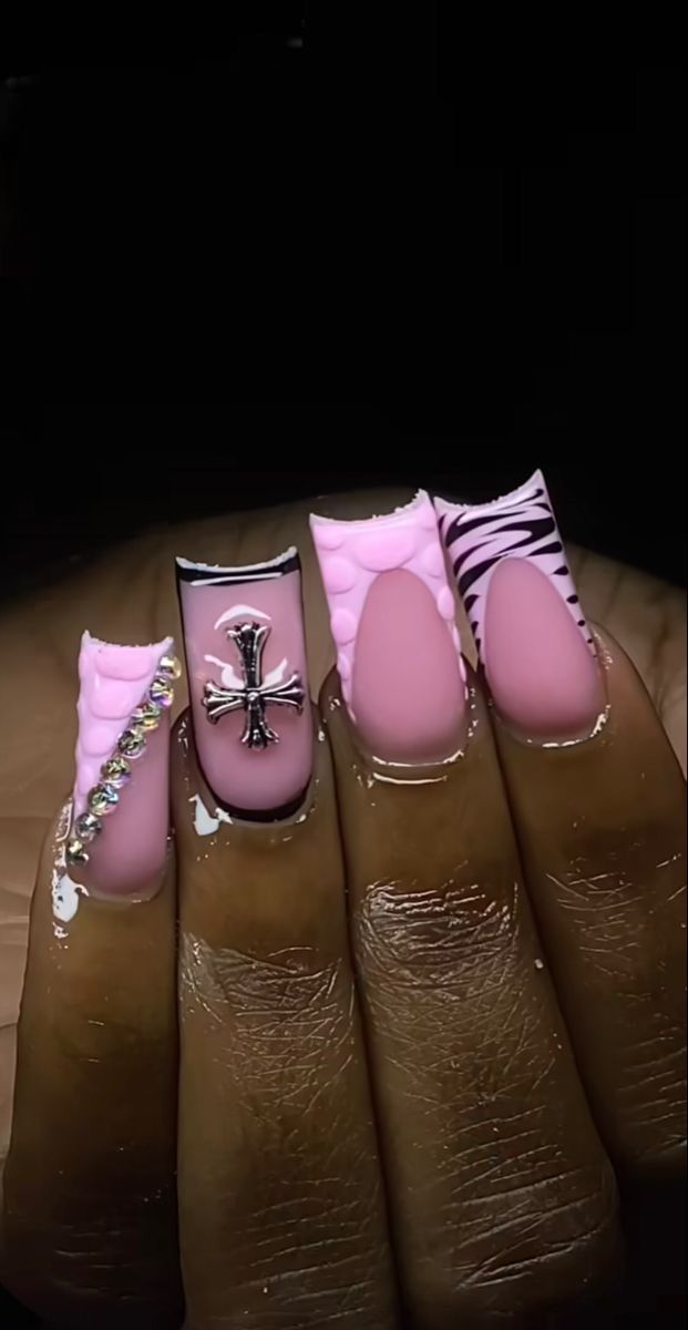 Bold Pink Nail Design with Patterns and Rhinestone Accents for a Chic Statement Look.