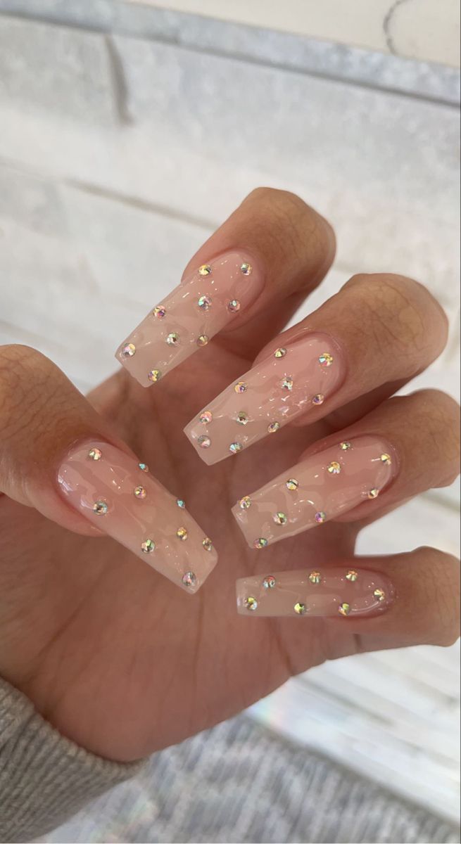 Elegant Sparkling Nude Nails with Multicolored Gemstones: A Perfect Balance of Subtlety and Glamour.