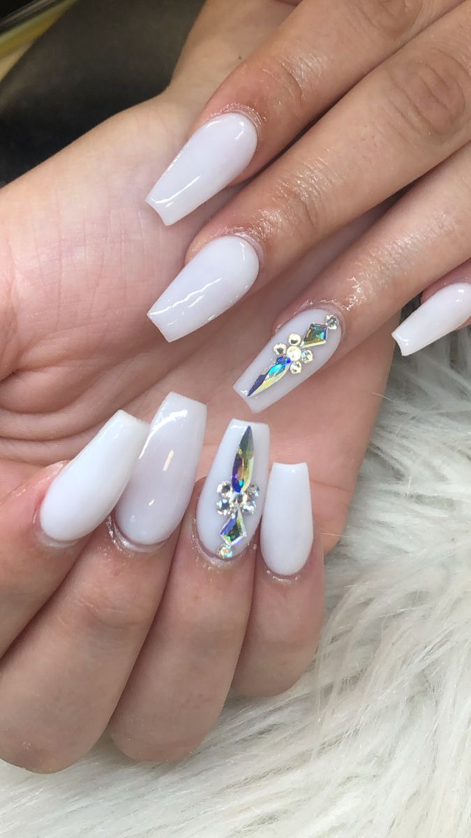 Sophisticated Long Glossy White Nails with Colorful Gemstone Accents for Elegant Manicures.