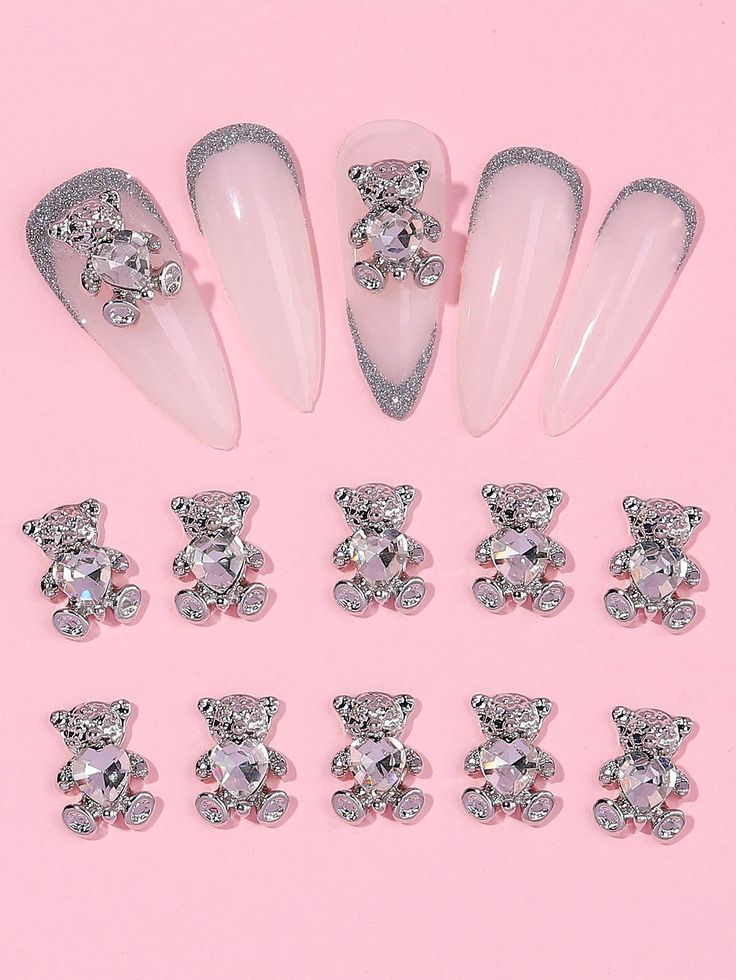 Elegant Stiletto Nail Design with Sparkly Bear Charms and Glamorous Glitter Tips