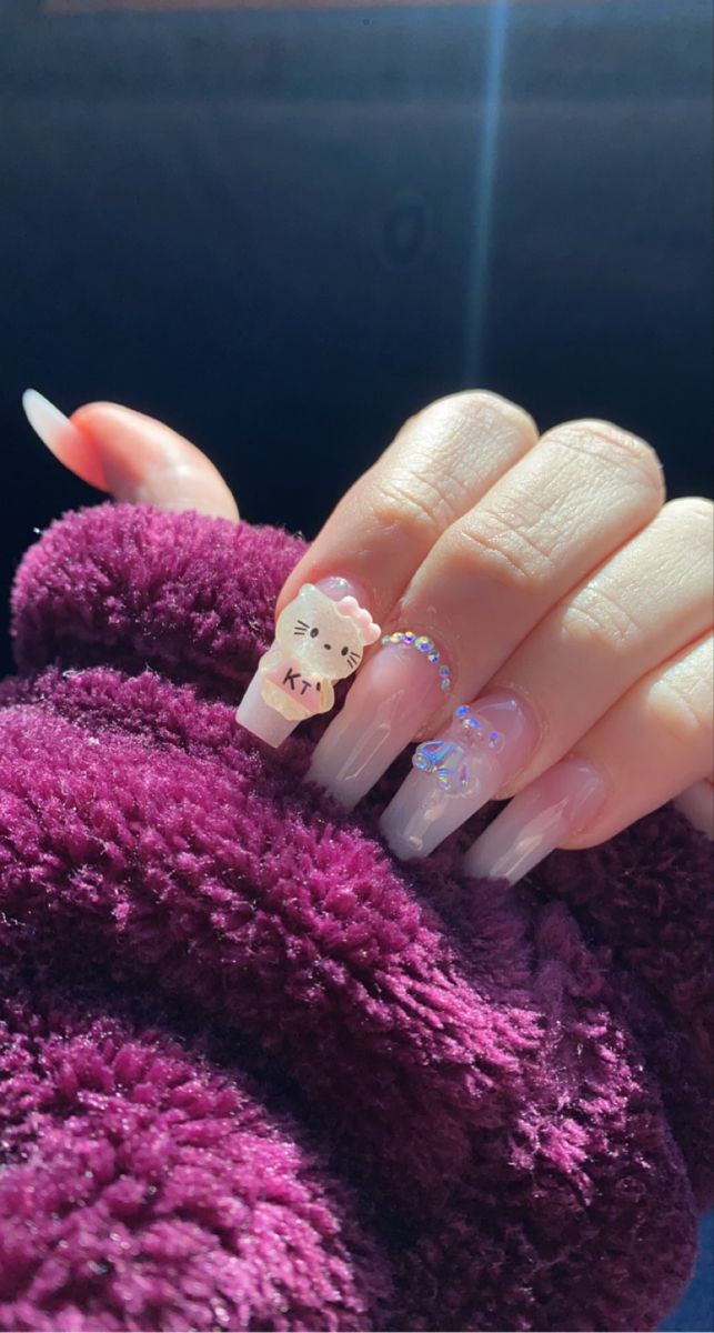 Playful Nail Design: Charming Character Accents and Shimmering Embellishments on Clear Long Nails.