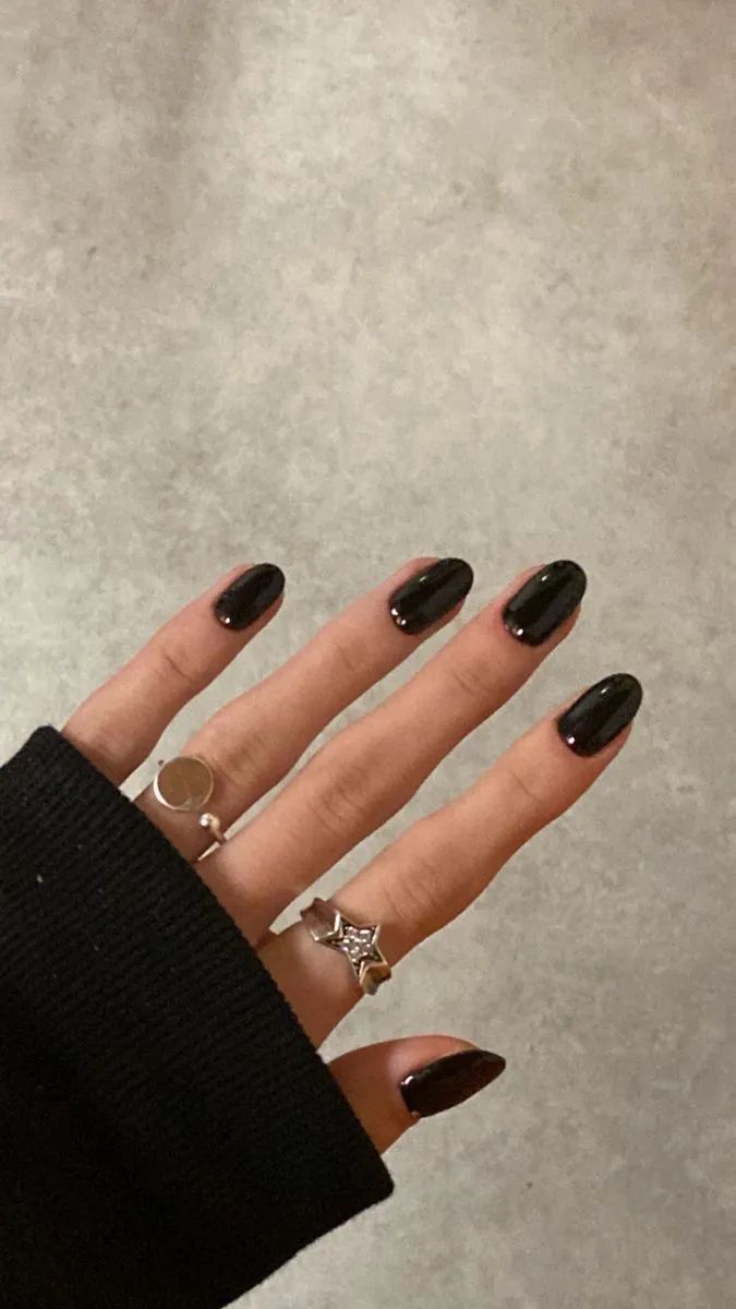 Elegant Glossy Black Oval Nails Enhanced by Delicate Rings