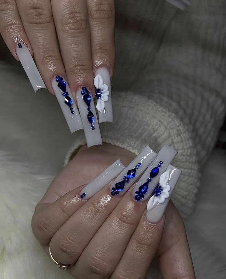 Chic Elegant Nail Art: Soft White Base Adorned with Blue Gemstones and White Flowers