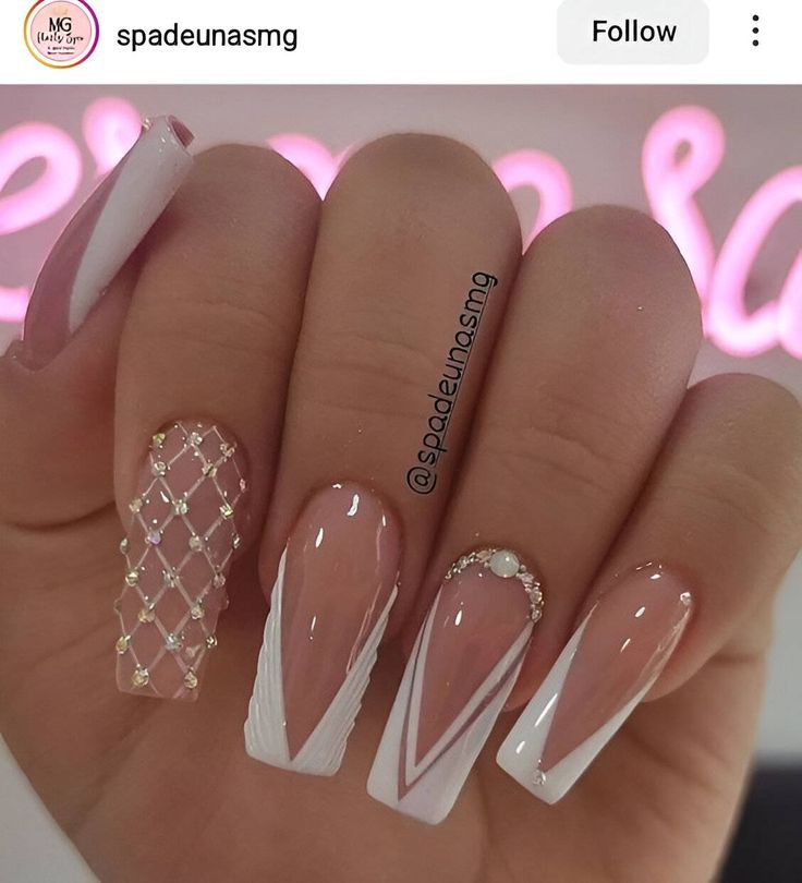 Sophisticated Nude and White Nail Design with Geometric Patterns and Luxurious Accents.