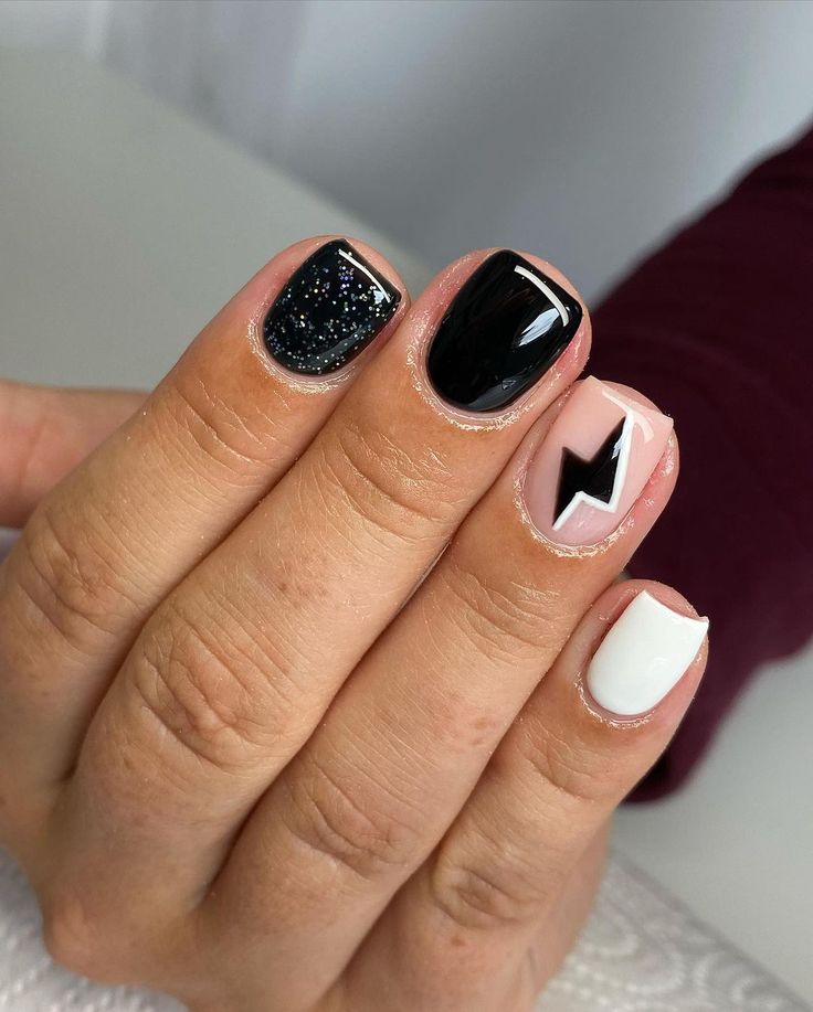 Playful Yet Sophisticated Geometric Nail Design with Black, White, and Nude Shades