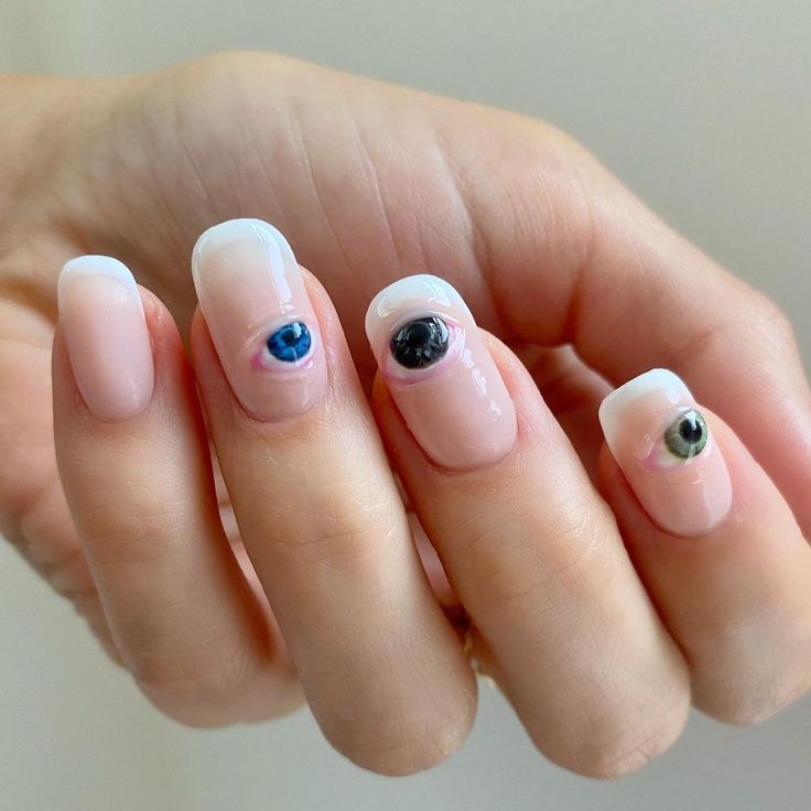 Eye-Catching Creative Nail Design: Classic French Manicure with Unique Colorful Eye Motifs