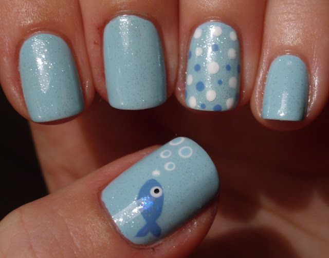 Whimsical Oceanic Nail Design with Shimmering Light Blue Base and Charming Whale Accents.