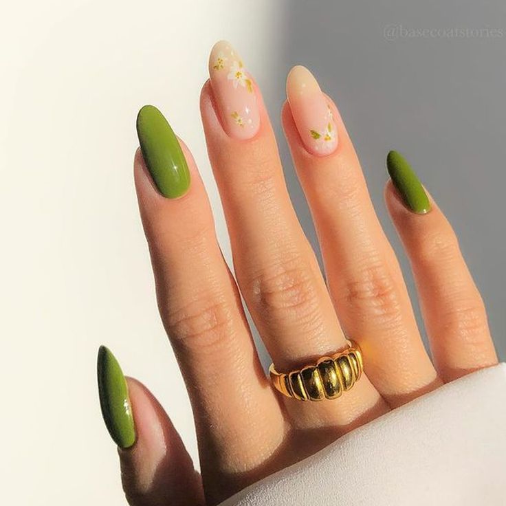 Elegant Nail Design: Matte Green, Soft Pink, and Glittering Floral Accents with Chic Gold Ring Accent.