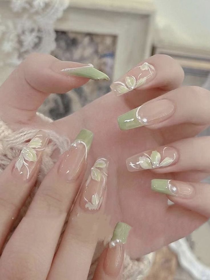 Elegant Floral Nail Design in Fresh Green with Hand-Painted White Accents.