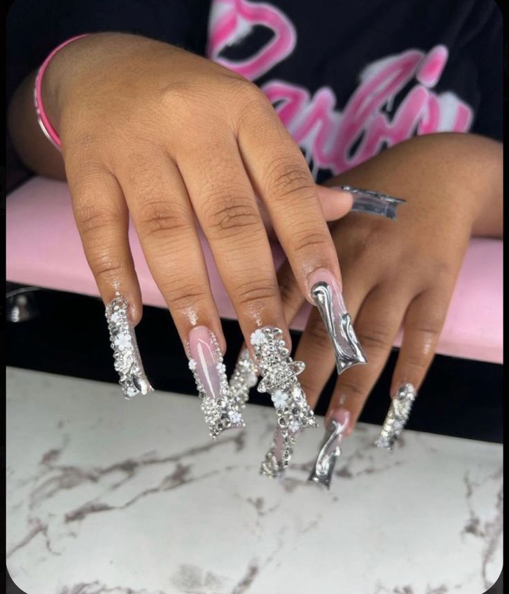 Intricate Long Acrylic Nail Design with Pink and Silver Embellishments.