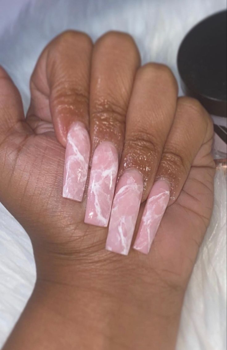 Elegant Marbled Pink Nail Design with Chic White Swirls.