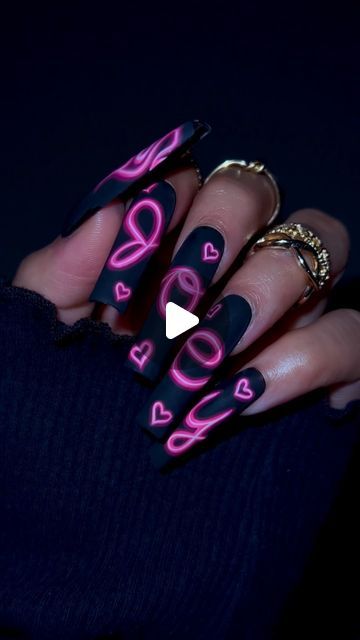 Trendy Bold Matte Black Nails with Vibrant Pink Patterns and Playful Symbols