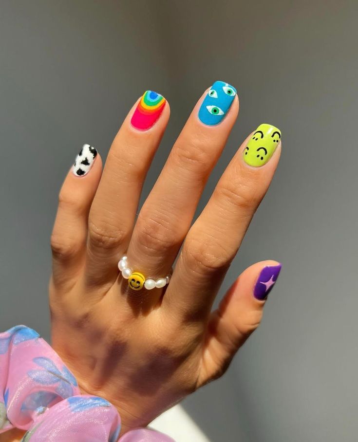 Playful and Vibrant Nail Design with Distinct Themes and Cheerful Accents.