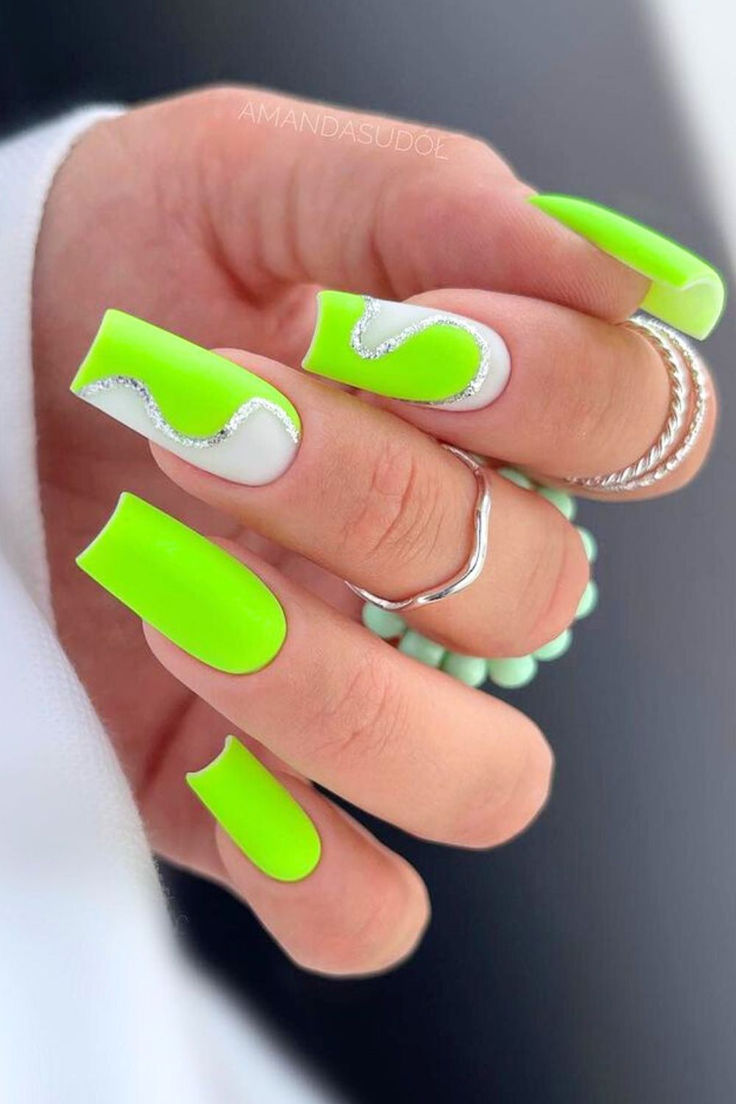 Bold Neon Green Nail Design with Intricate Patterns and Sparkly Accents