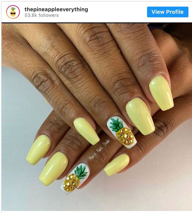 Tropical-Inspired Bright Yellow Nail Design with Pineapple Accents and Gold Rhinestones.